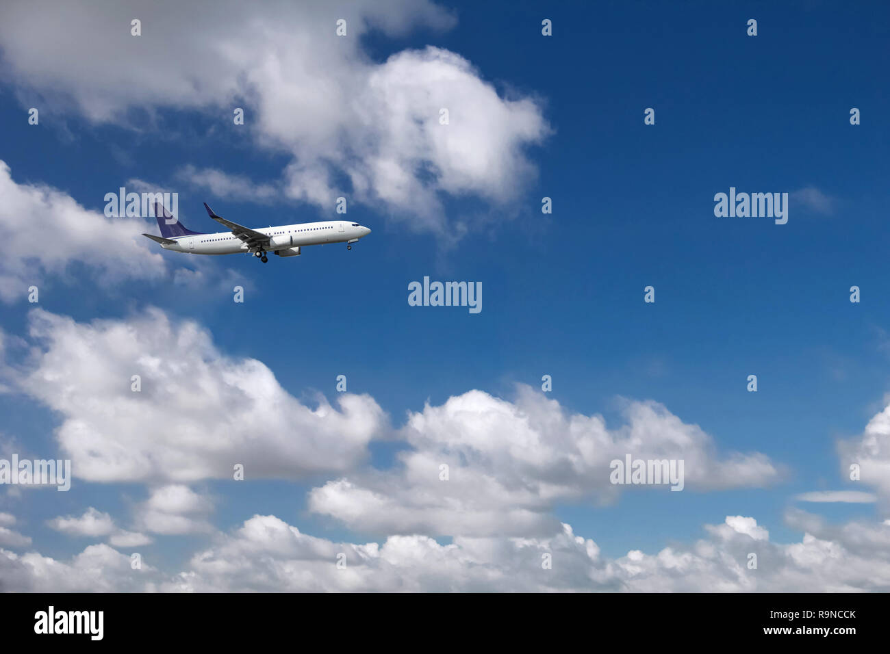 Passenger airplane on the background of blue sky and white clouds ...