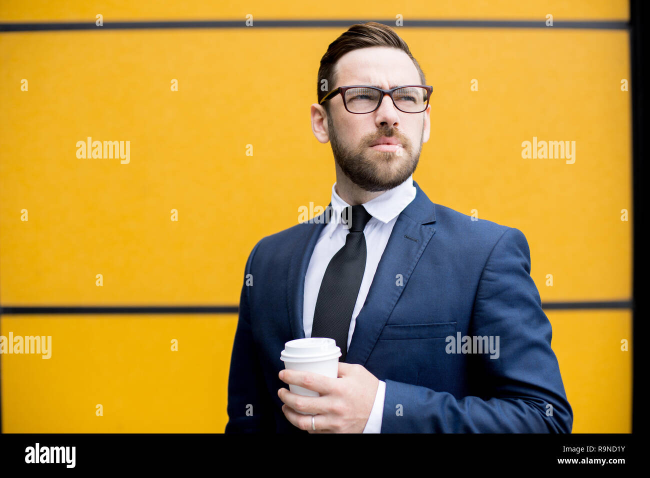 Handsome man holding cup of hot drink  Stock Photo