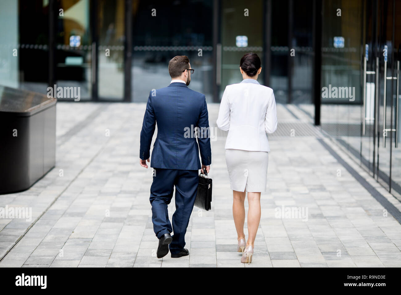 Formal man and woman going to office building Stock Photo