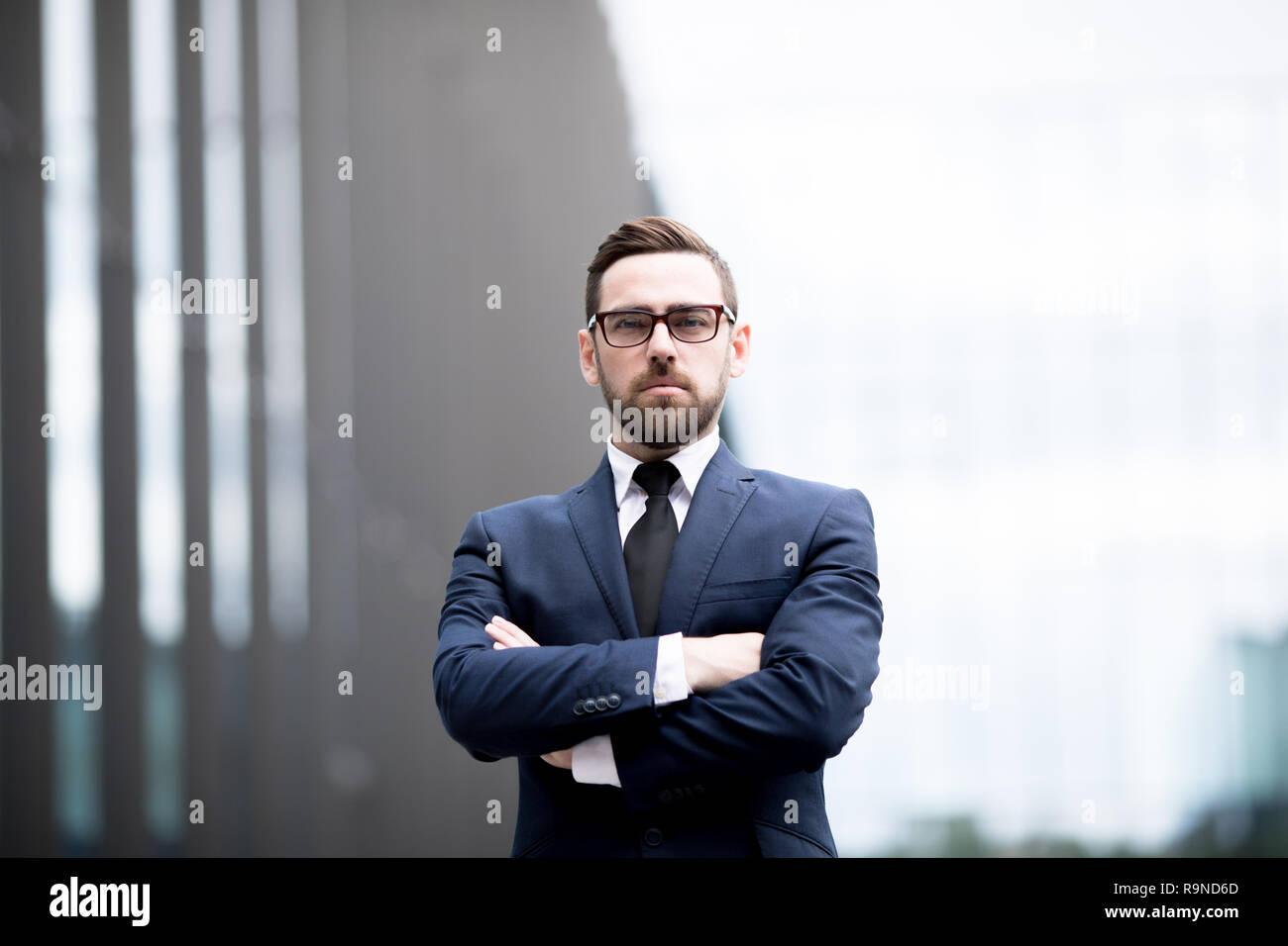 Confident businessman standing with arms crossed Stock Photo