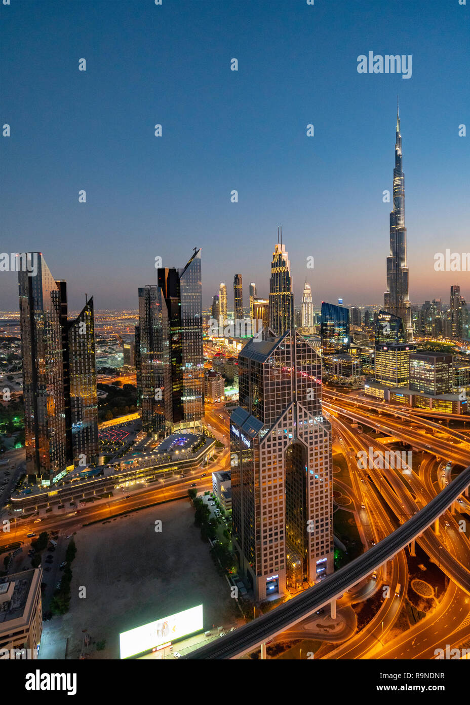 Skyline of Dubai and Burj Khalifa skyscraper at dusk in Dubai, United Arab Emirates Stock Photo