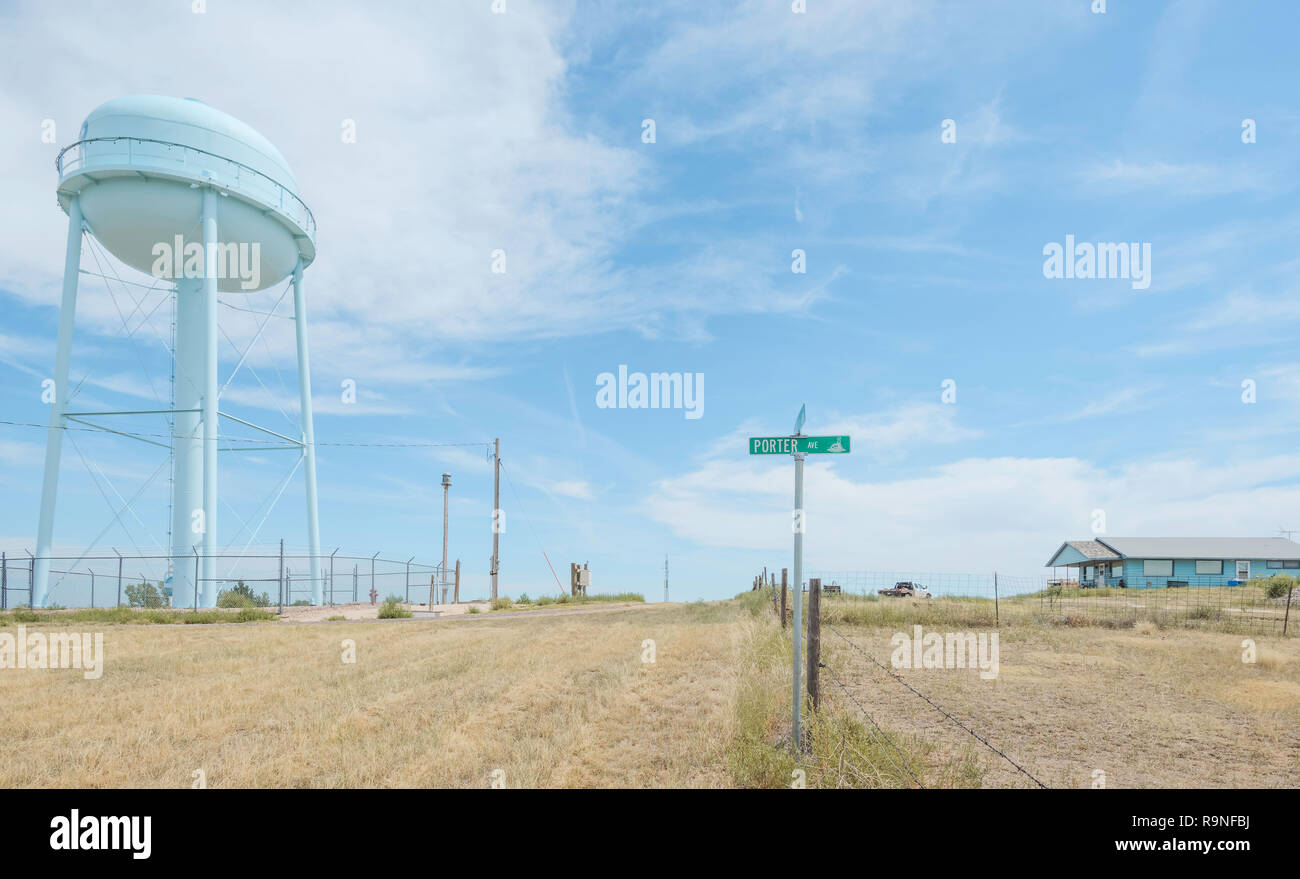 Porter Avenue and elevated water tank with wooden house on a hot summer