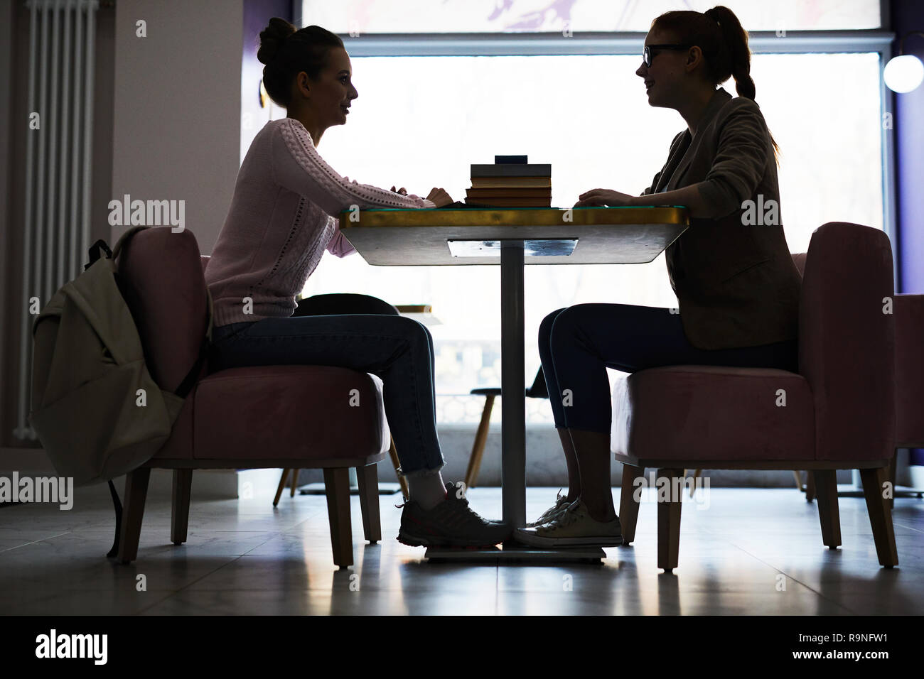 Conversation by table Stock Photo Alamy