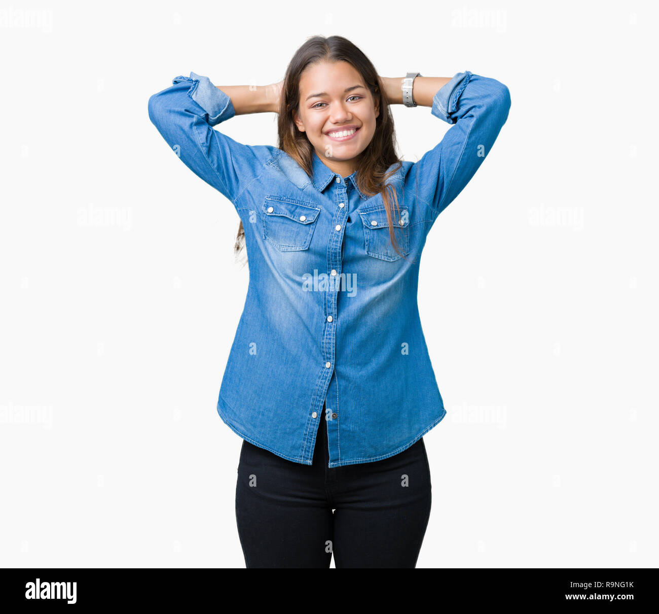 Young beautiful brunette woman wearing blue denim shirt over isolated  background Relaxing and stretching with arms and hands behind head and  neck, smi Stock Photo - Alamy