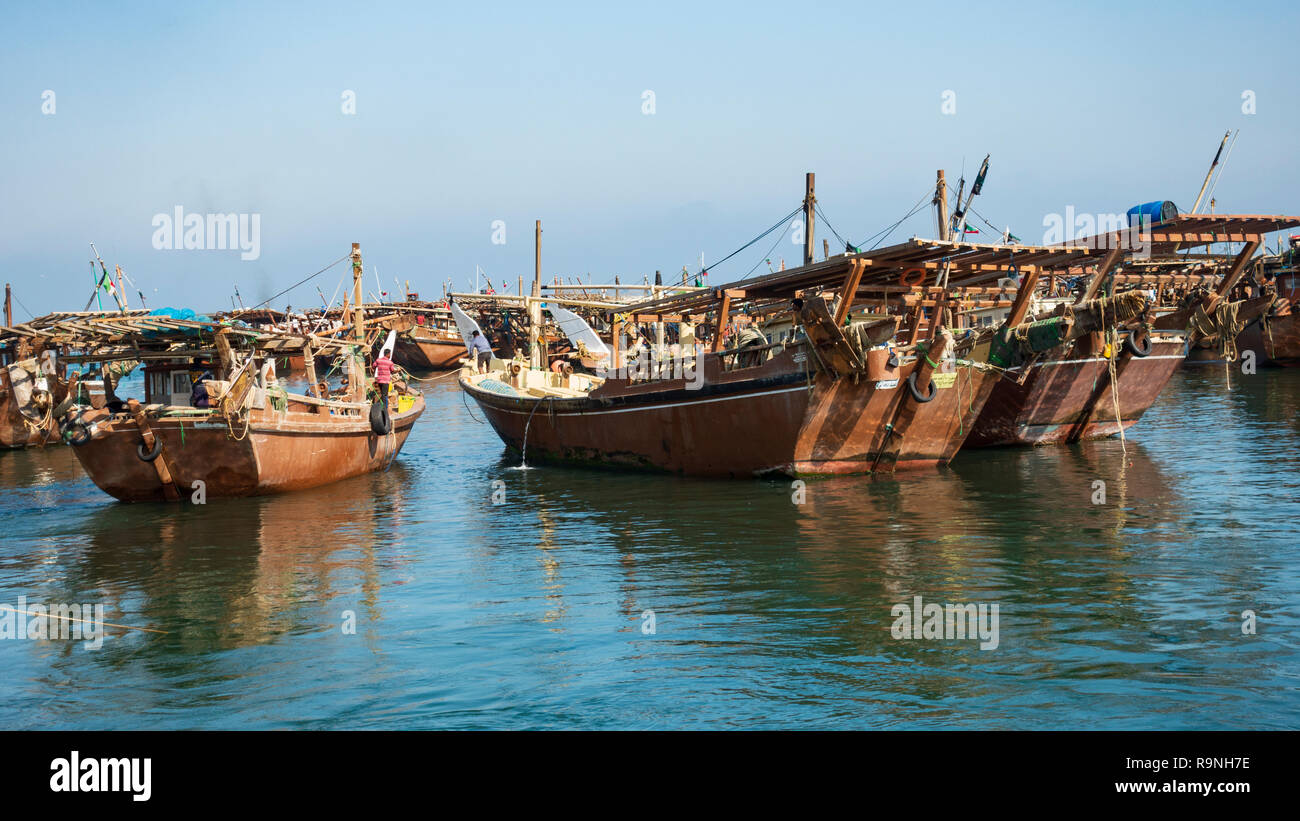 Traditional dhow fishing boasts in fishing harbour at Nag'aat Al Kout in Fahaheel , Kuwait, Middle East. Stock Photo