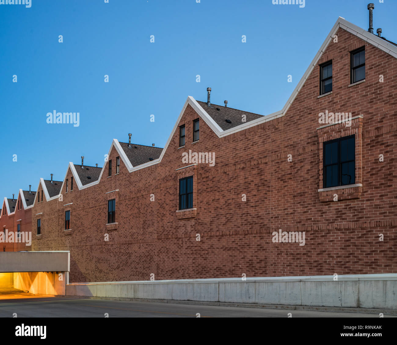 Suburban apartment building and parking garage Stock Photo