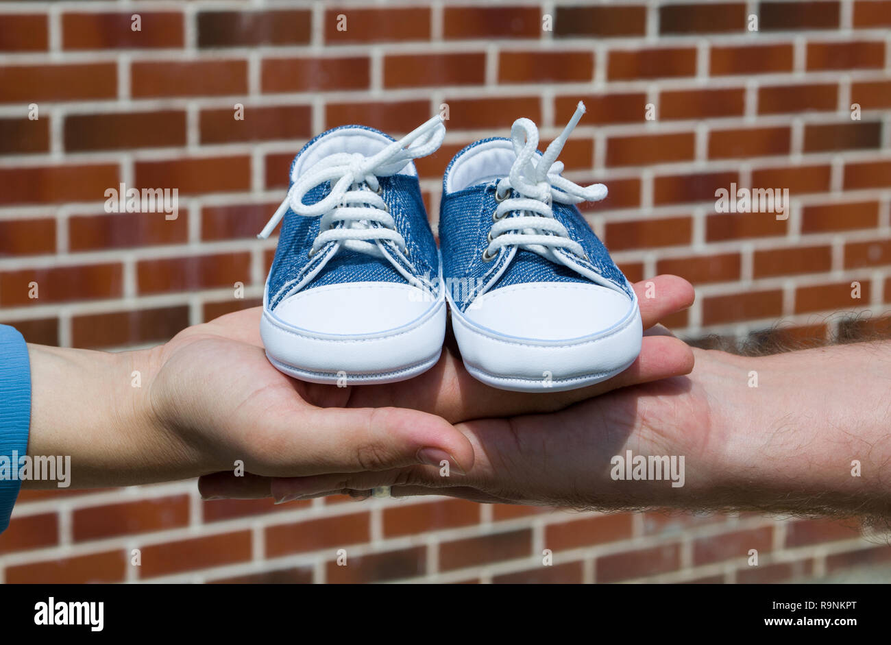 Future parents holding baby shoes Stock Photo