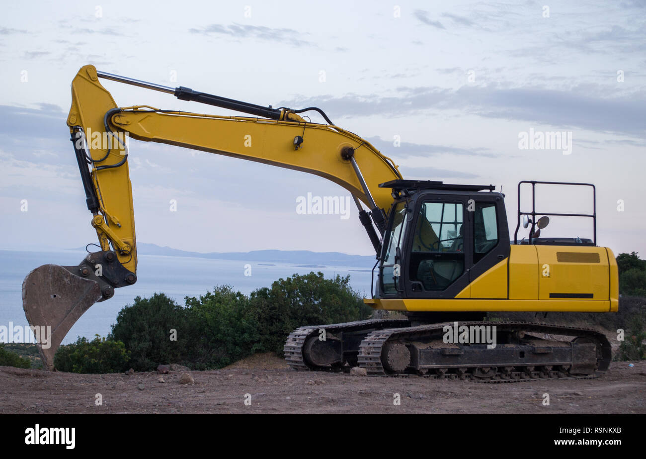 Excavator at a construction site near the sea Stock Photo - Alamy