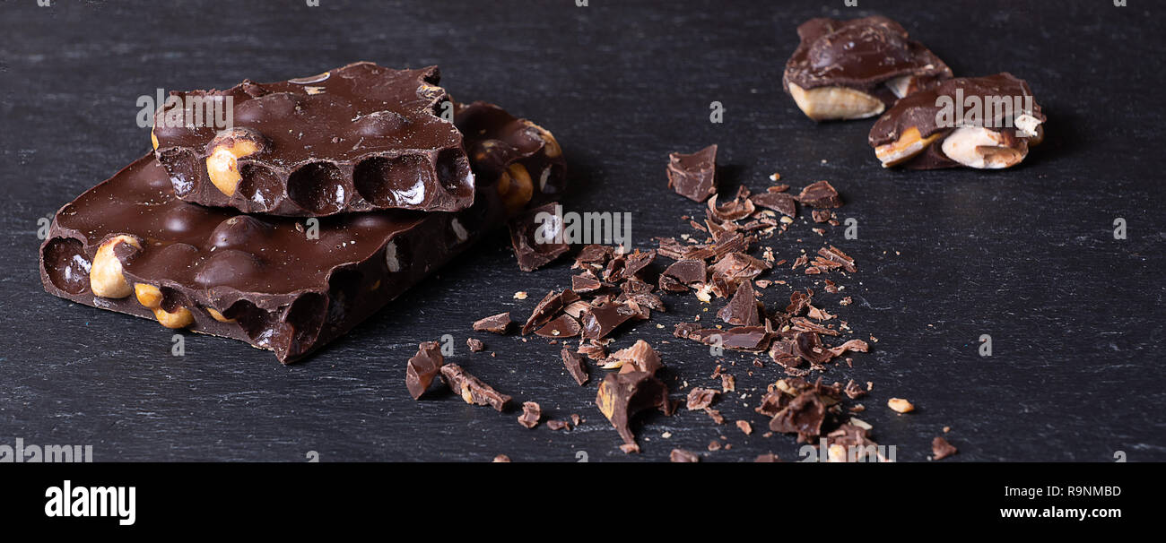 Dark chocolate stack on a black background, banner Stock Photo - Alamy