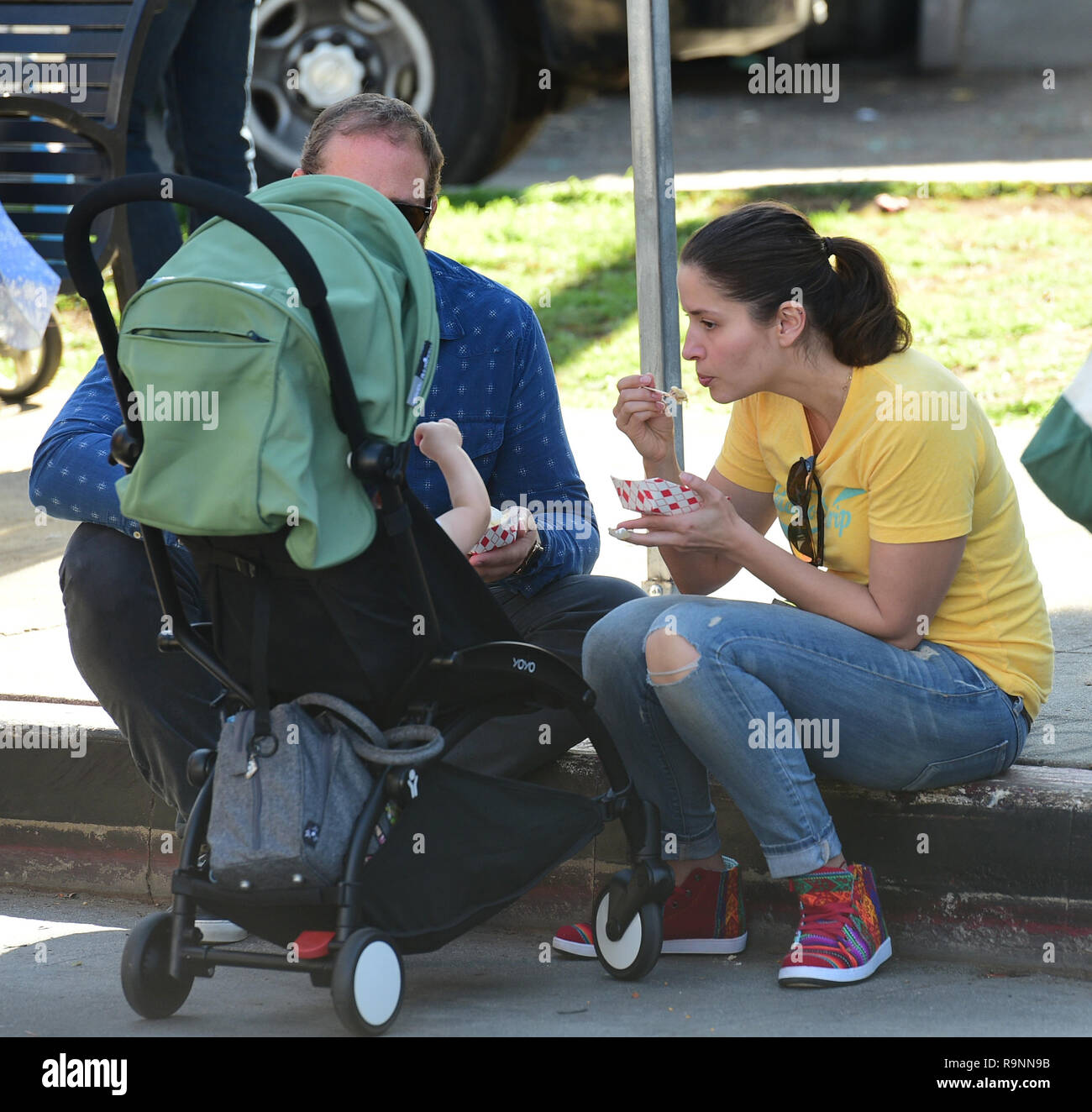 Mercedes Mason feeds her son Caius Kane at the farmers market with her