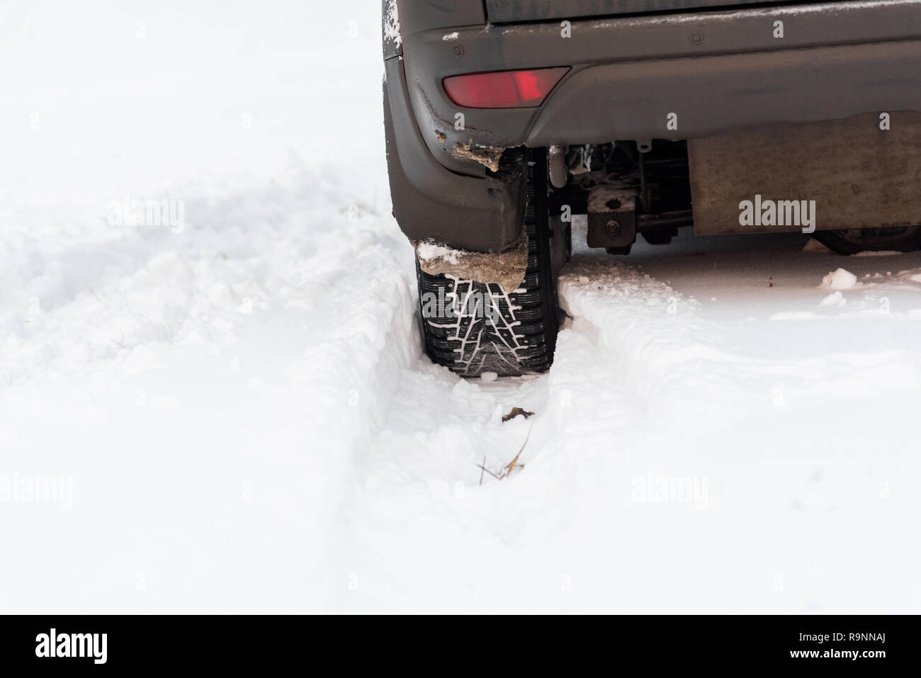 Moscow, Russia - December 25, 2018: The wheel is buried in the snow. The car goes on a winter field. Stock Photo