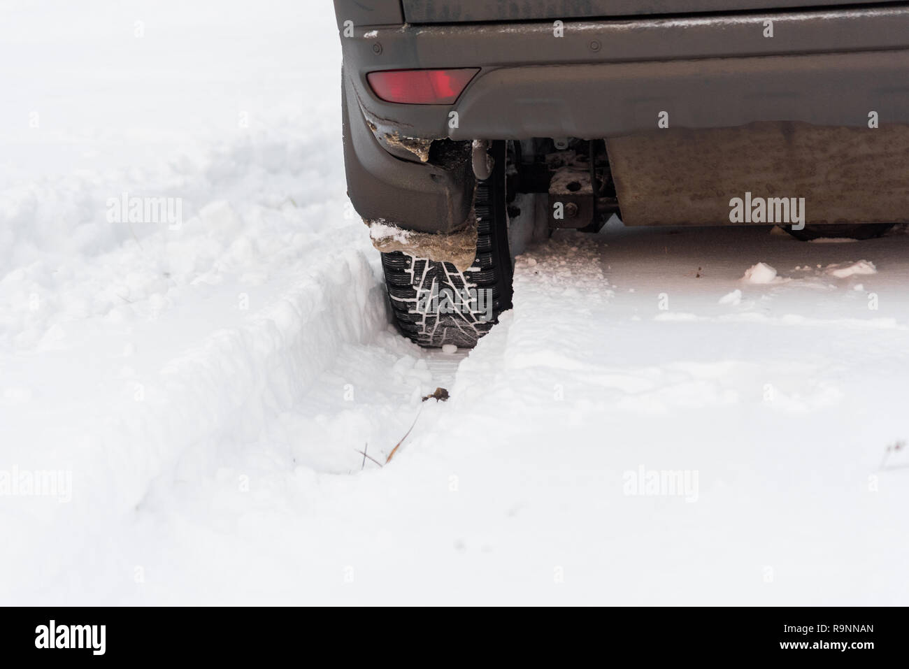 Moscow, Russia - December 25, 2018: The wheel is buried in the snow. The car goes on a winter field. Stock Photo