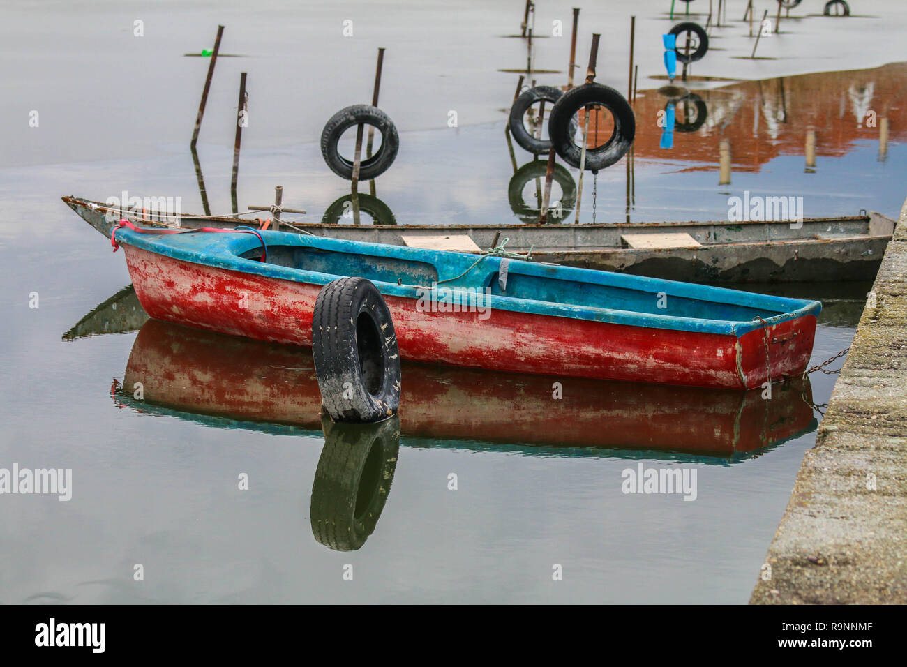 https://c8.alamy.com/comp/R9NNMF/small-old-wood-fishing-boats-floating-on-the-water-they-are-standing-on-the-small-dock-R9NNMF.jpg