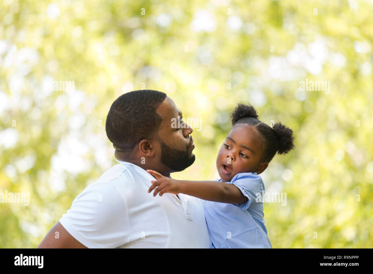 African American father parenting and talking with his daughter. Stock Photo