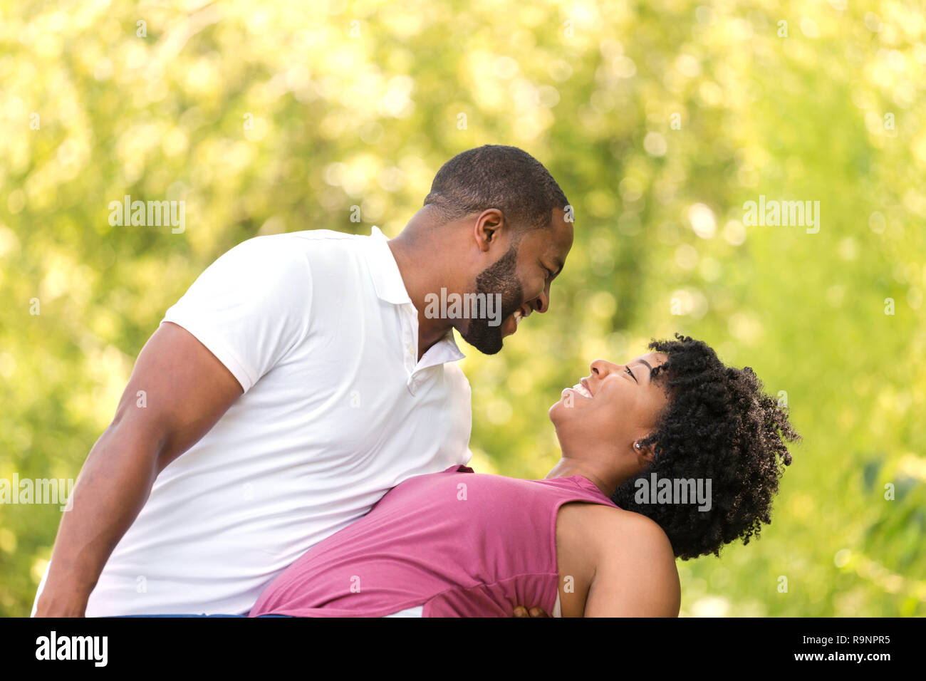 Happy African American couple laughing and smiling Stock Photo - Alamy