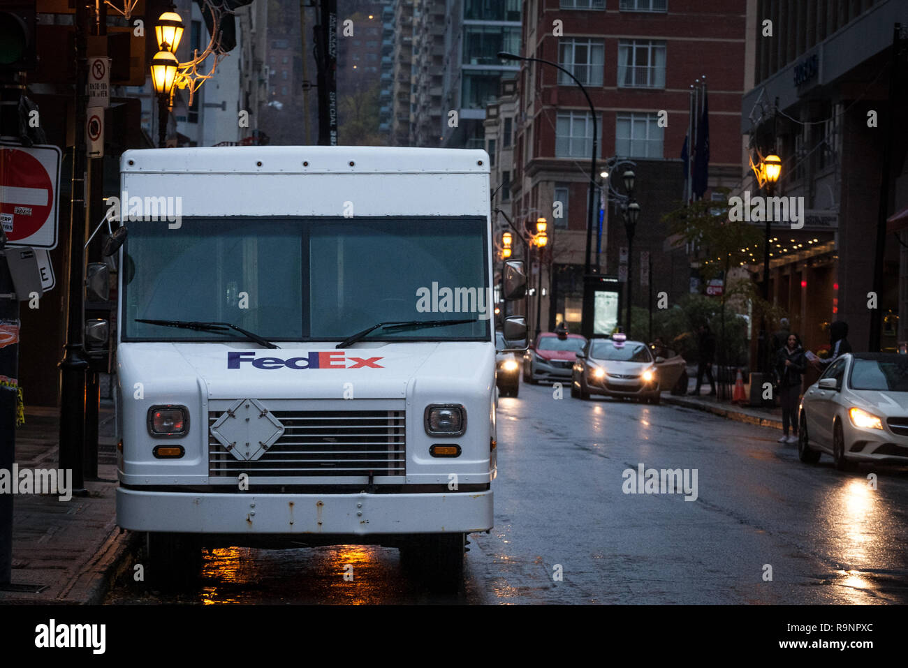 MONTREAL, CANADA - NOVEMBER 5, 2018: Fedex logo on one of their delivery trucks in a street of Montreal, Quebec. Fedex is an American courier speciali Stock Photo