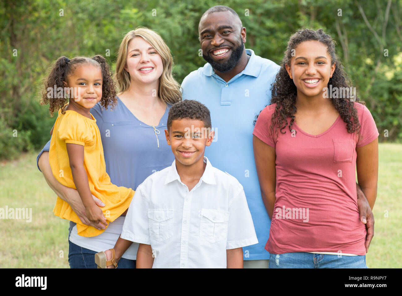 Portarit of a happy mixed race family smiling Stock Photo