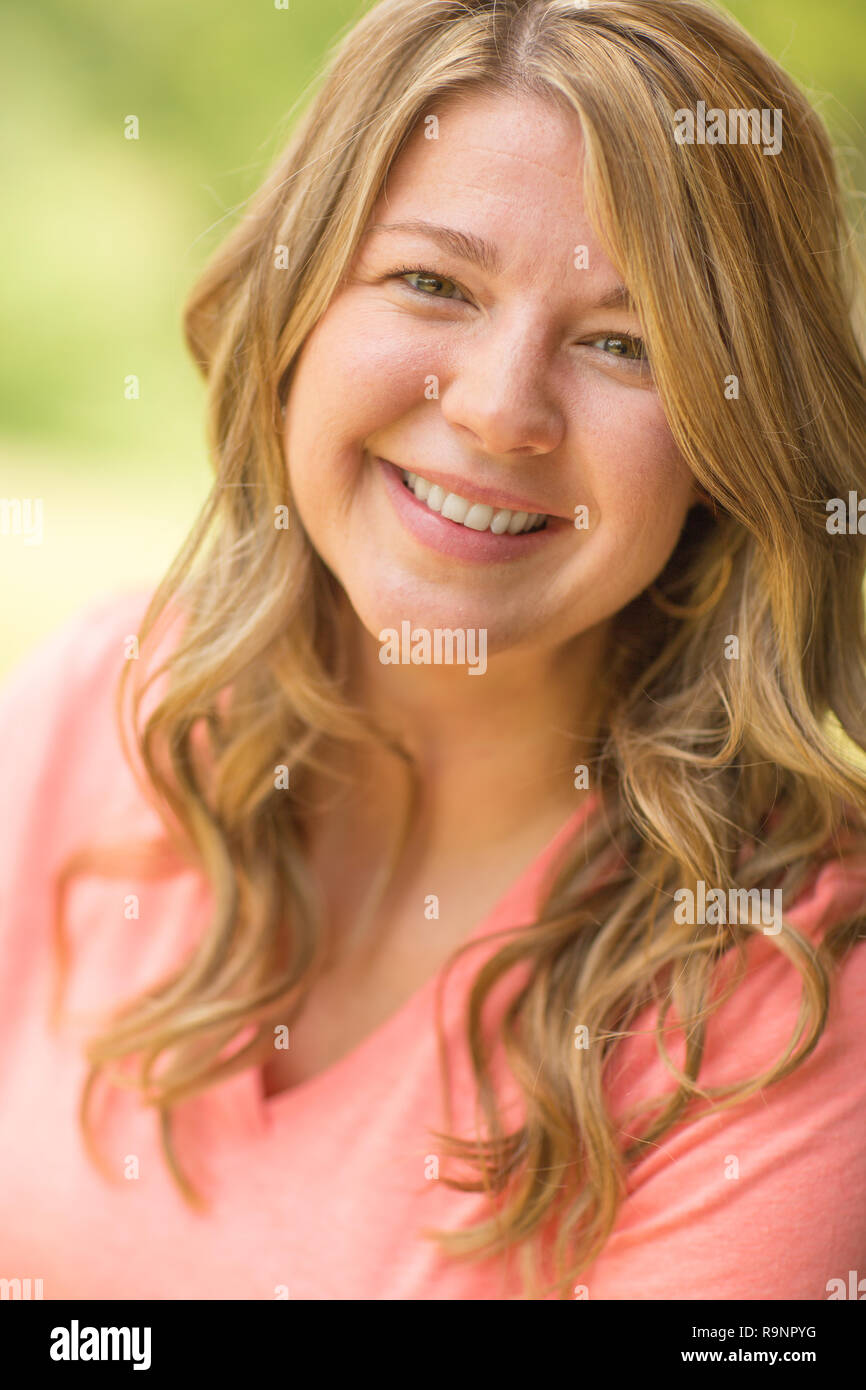 Portrait of a happy woman smiling outside. Stock Photo