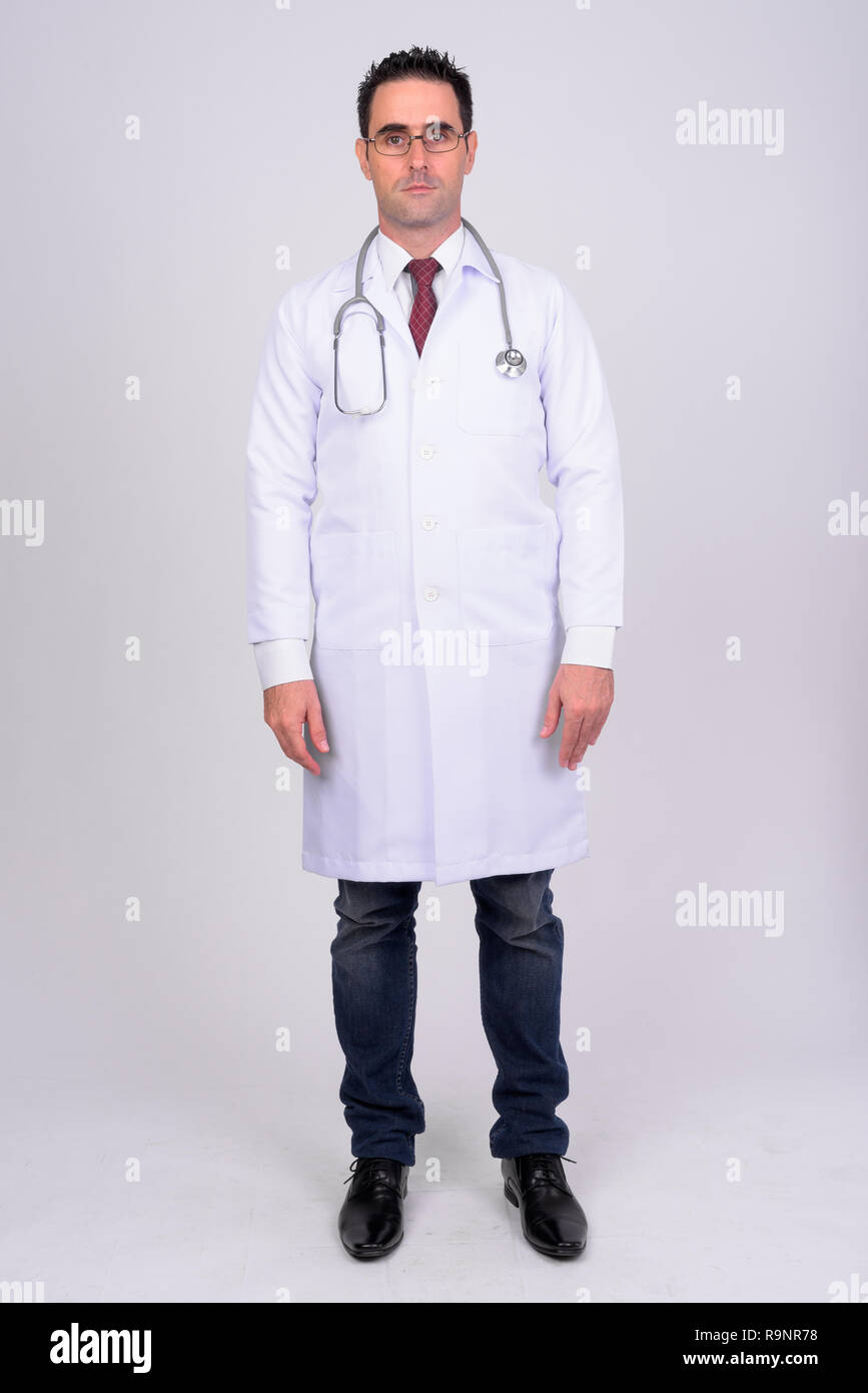 Full body shot of handsome man doctor against white background Stock ...