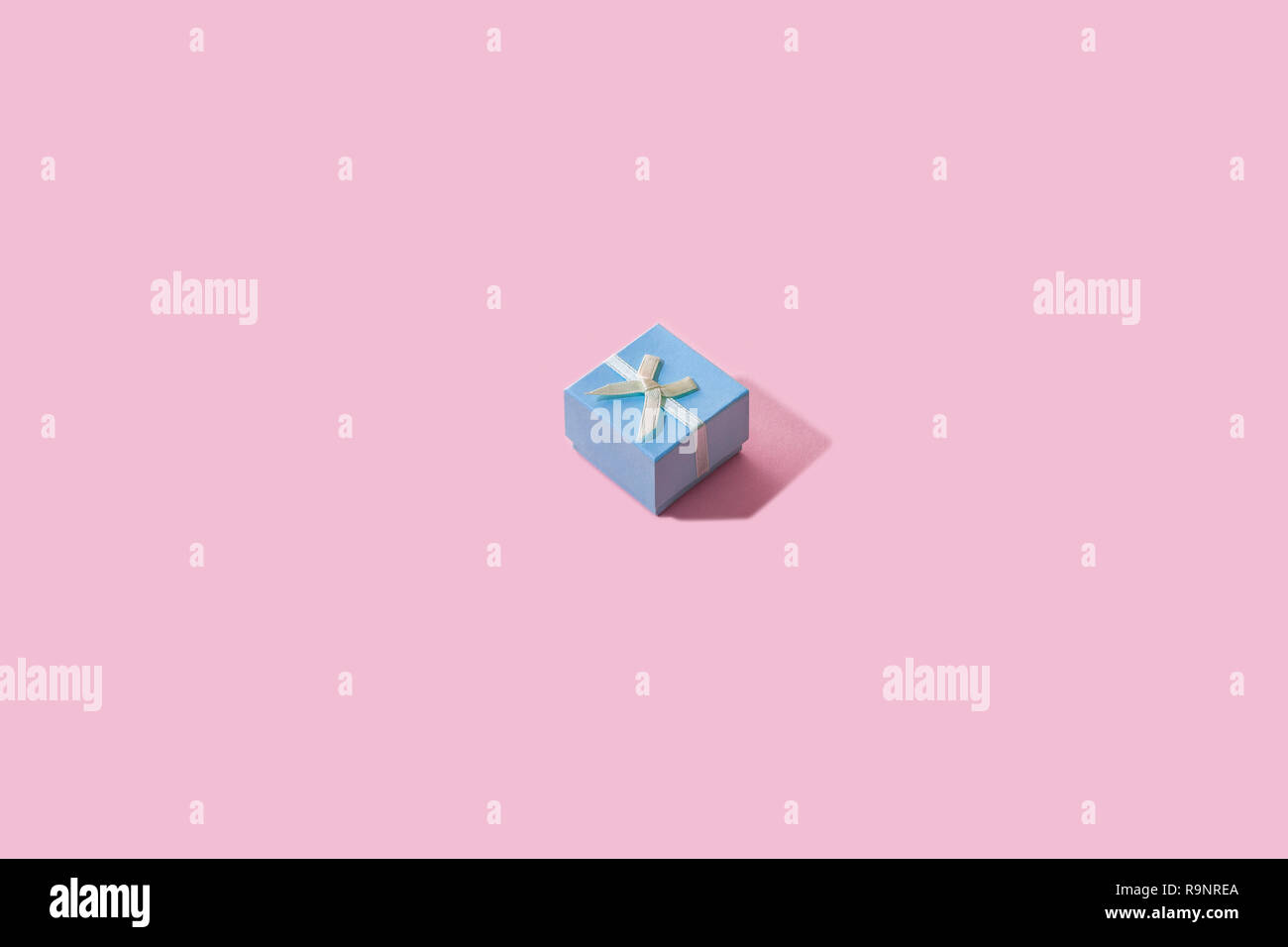 Blue Gift Box. Pink background. Stock Photo