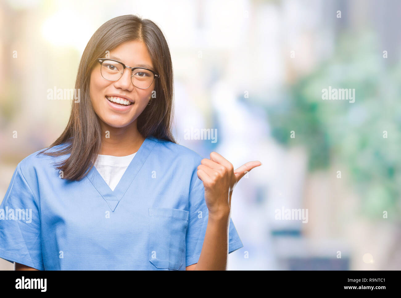 Young asian doctor woman over isolated background smiling with happy ...