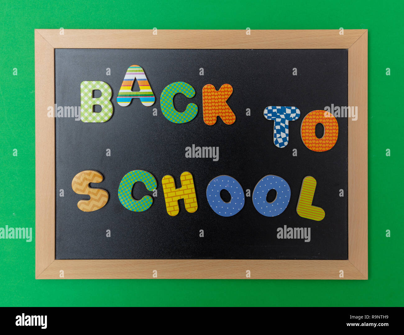 School concept. Black chalkboard with wooden frame, text back to school ...