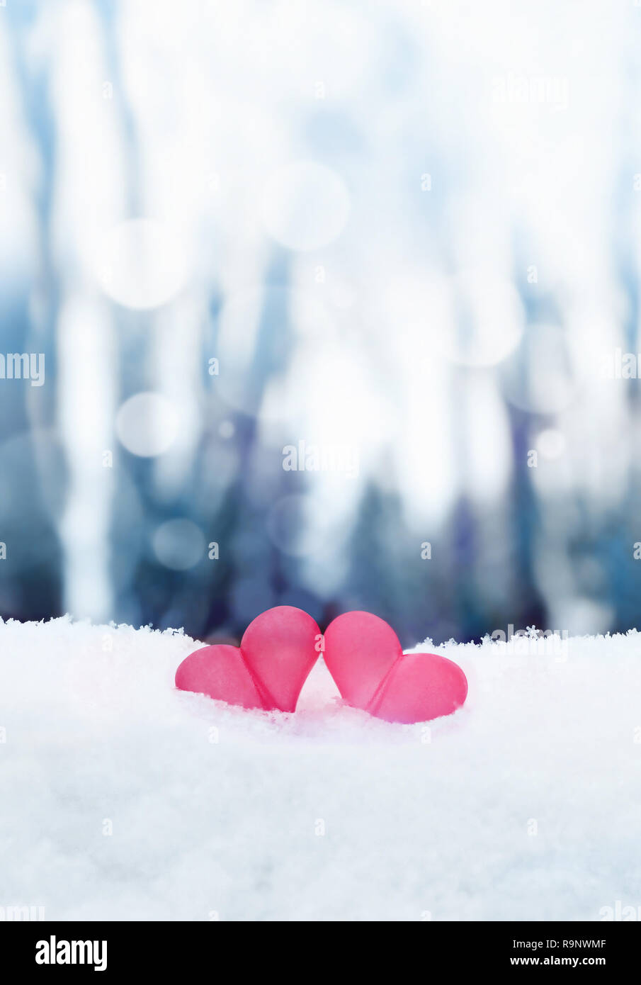 Beautiful romantic vintage red hearts together on white snow winter. Love and St. Valentines Day concept Stock Photo