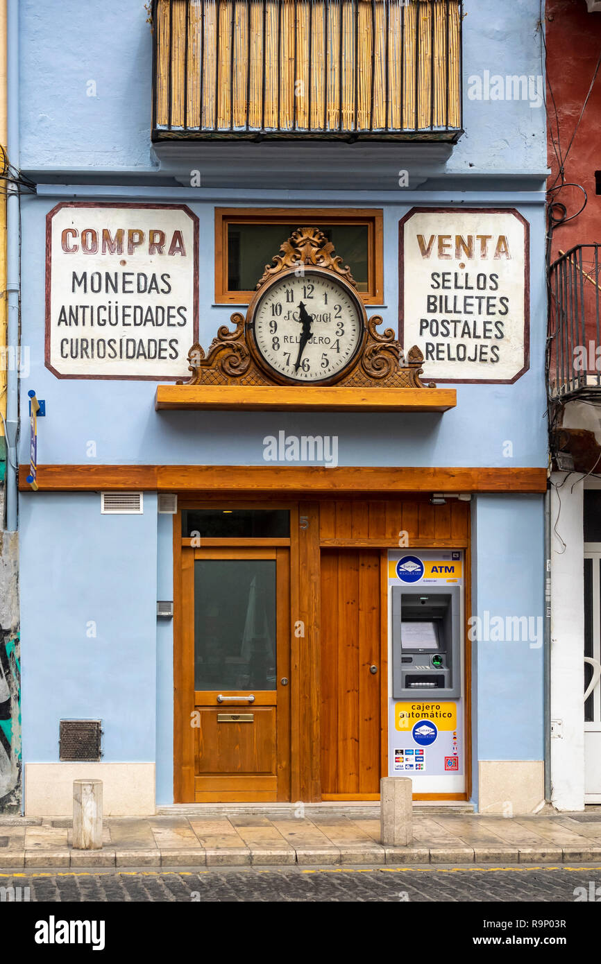 VALENCIA, SPAIN - MAY 24, 2018:  Signage and clock on shop in the city centre Stock Photo