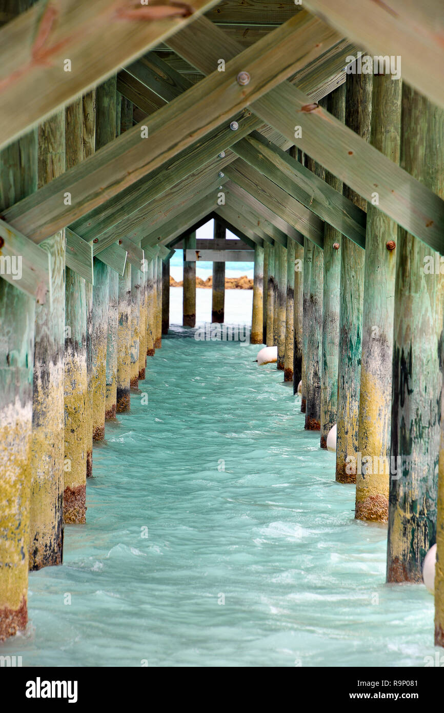 underside view of rustic wooden pier in Nassau Bahamas Stock Photo