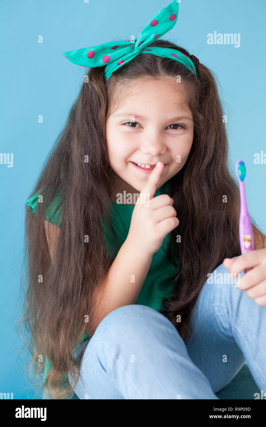 little girl brushing his teeth with a toothbrush dentistry tooth Stock