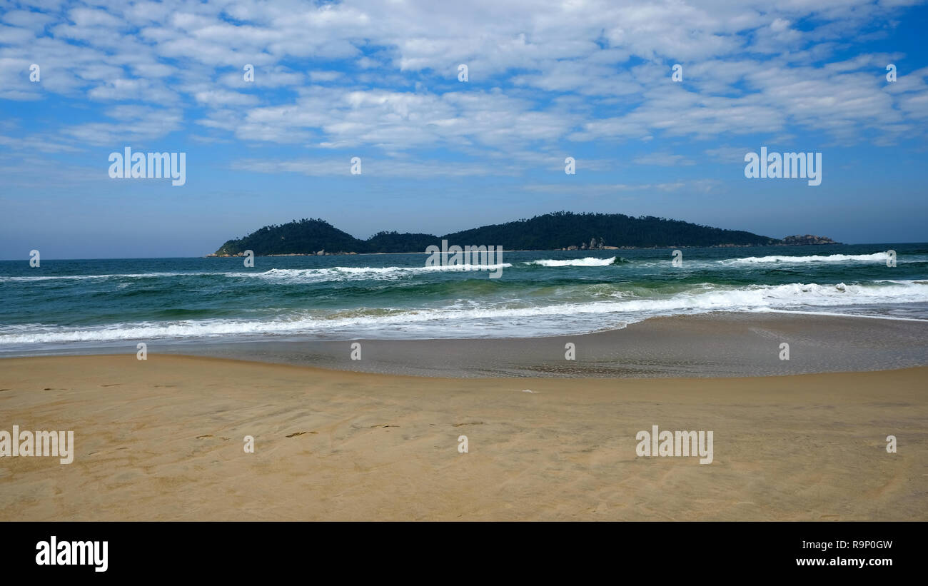 View of the small island Campeche island from the beach. Nice clouds in the blue sky