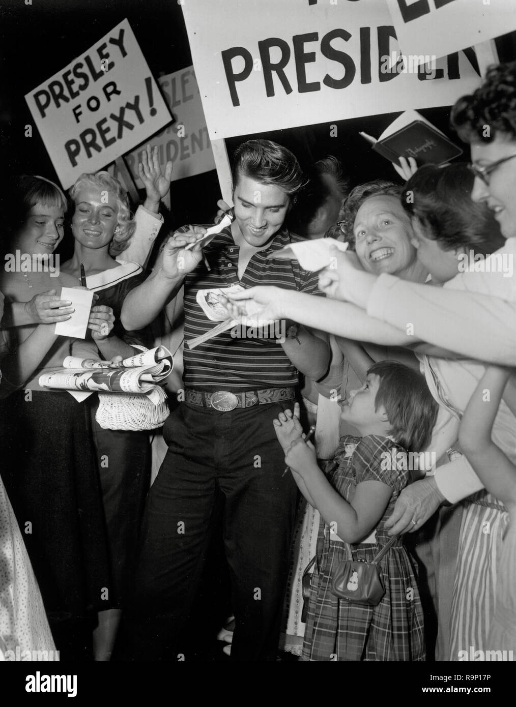 Elvis Presley, signs autographs for fans in Los Angeles, CA, circa 1957 File Reference # 33635 708THA Stock Photo