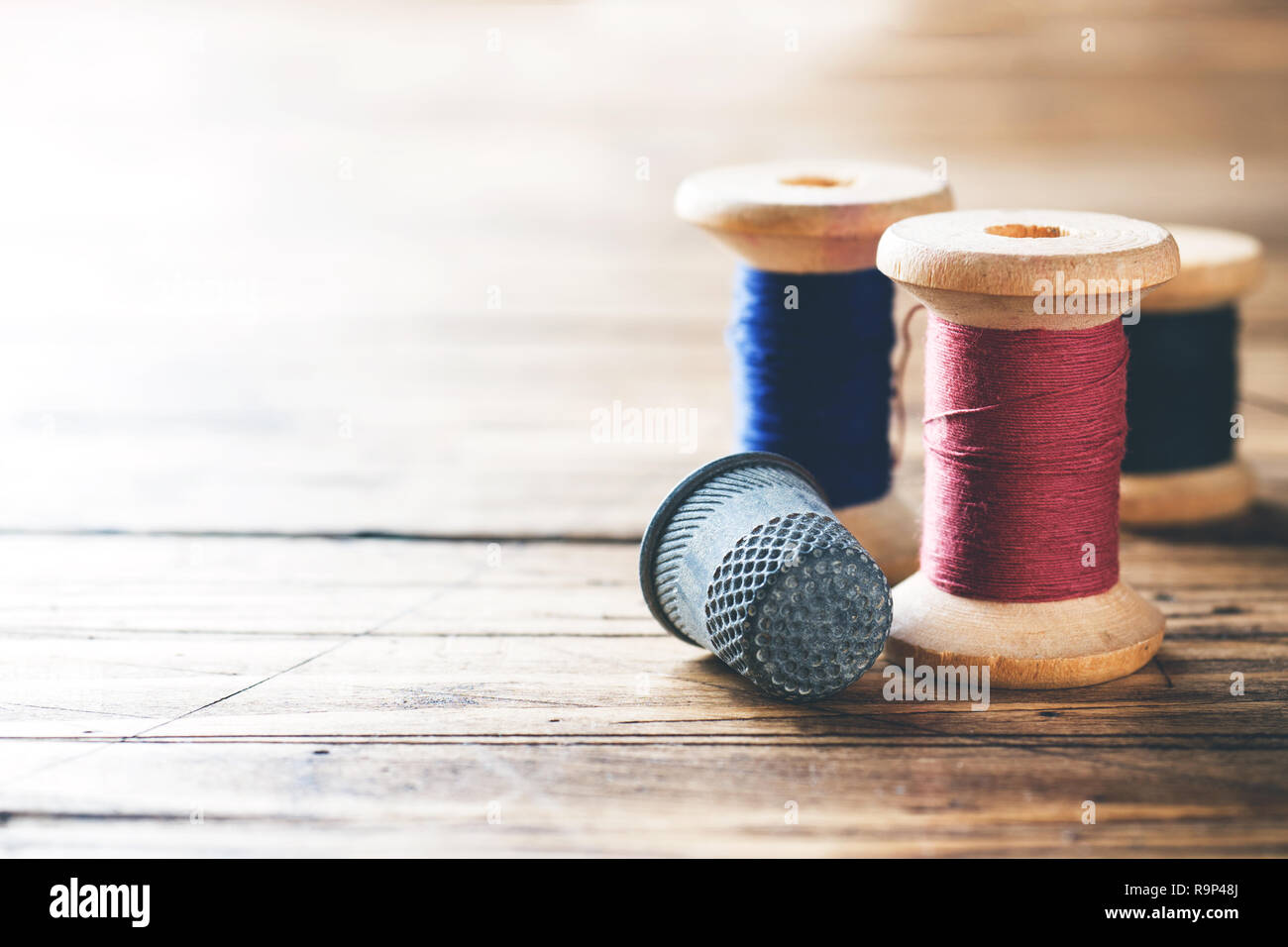 brown thread twisted into a spool on a wooden background 18964722 Stock  Photo at Vecteezy