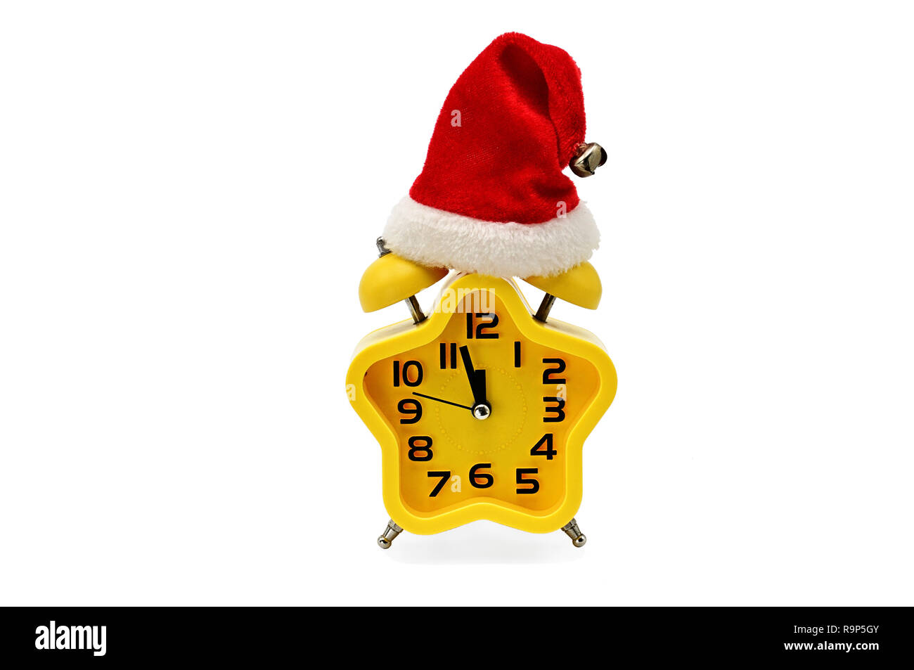 An asterisk Christmas clock shows the remaining time until midnight with a Santa Claus hat,on an isolated white background.Yellow.12,Twelve o'clock Stock Photo
