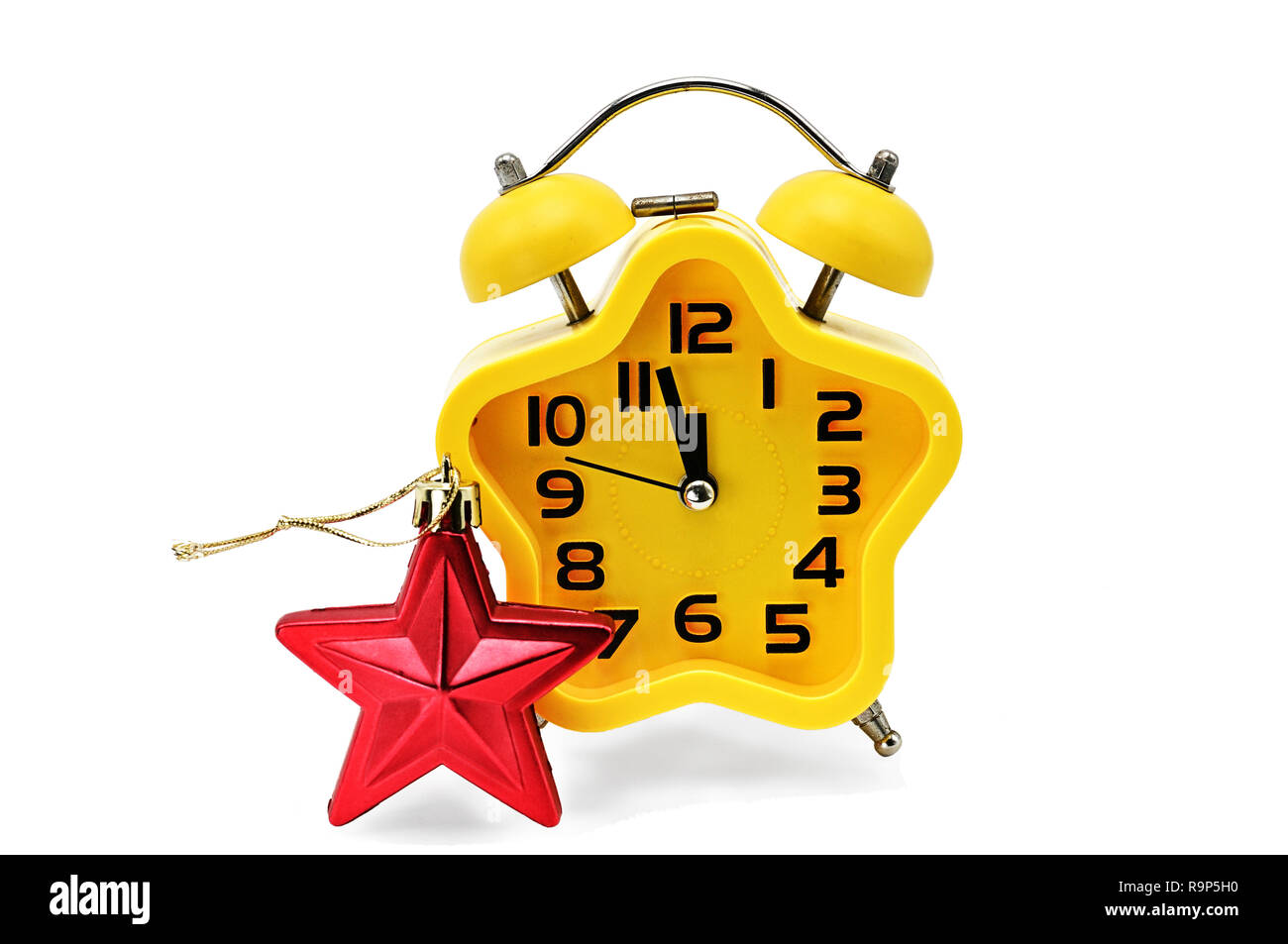 An asterisk Christmas clock shows the remaining time until midnight with a red asterisk,on an isolated white background.Yellow.12,Twelve o'clock Stock Photo