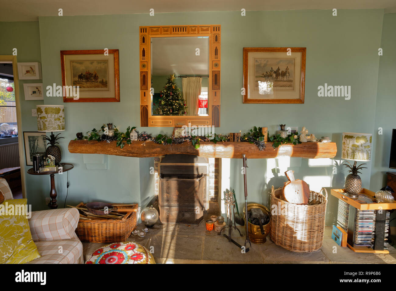 English drawing room at Christmas. Fireplace and decorated mantlepiece. Stock Photo