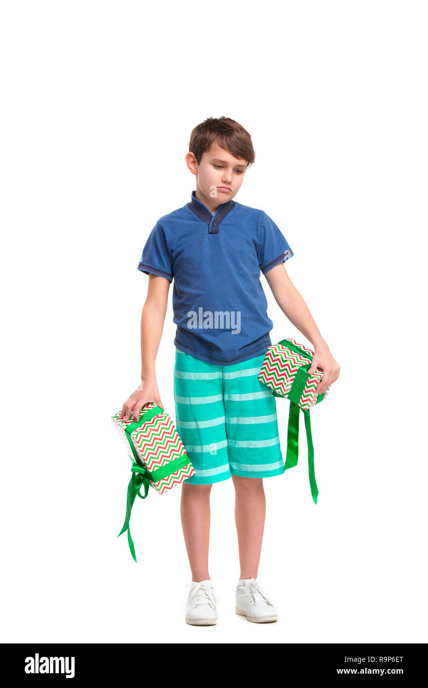 Displeased teenager boy with his present. Kids fashion concept Stock Photo