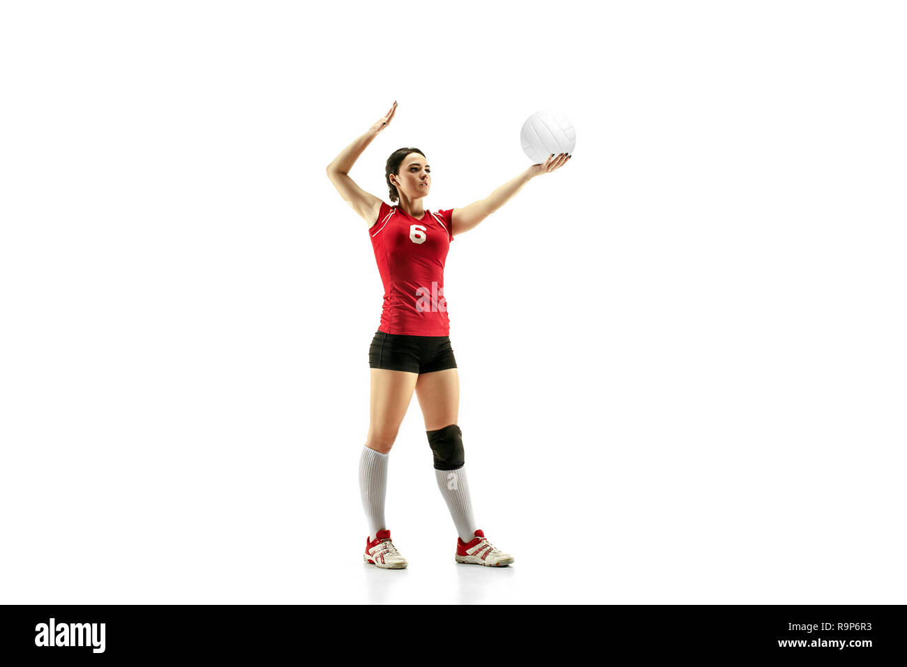 Female professional volleyball player isolated on white with ball. The