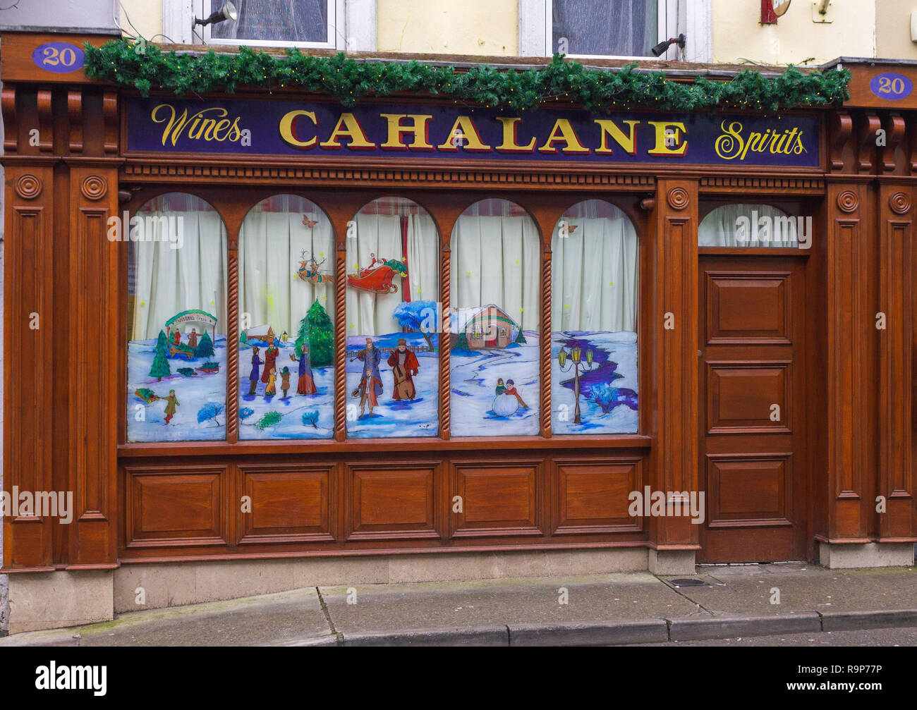 Christmas winter scene painted on an Irish pub window. Skibbereen West Cork Ireland Stock Photo