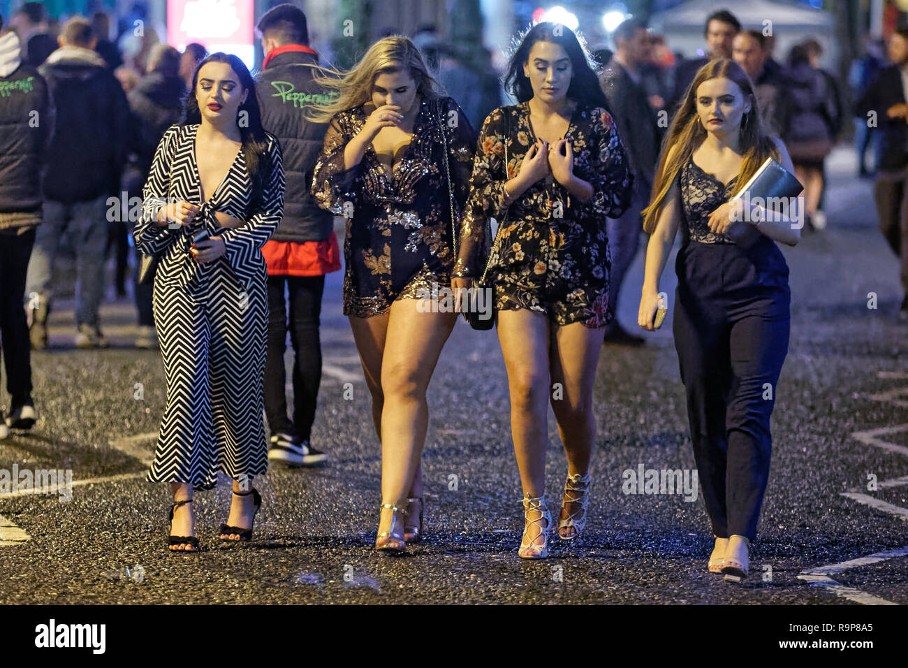 Pictured Four women walk in Wind Street, Swansea, south Wales, UK