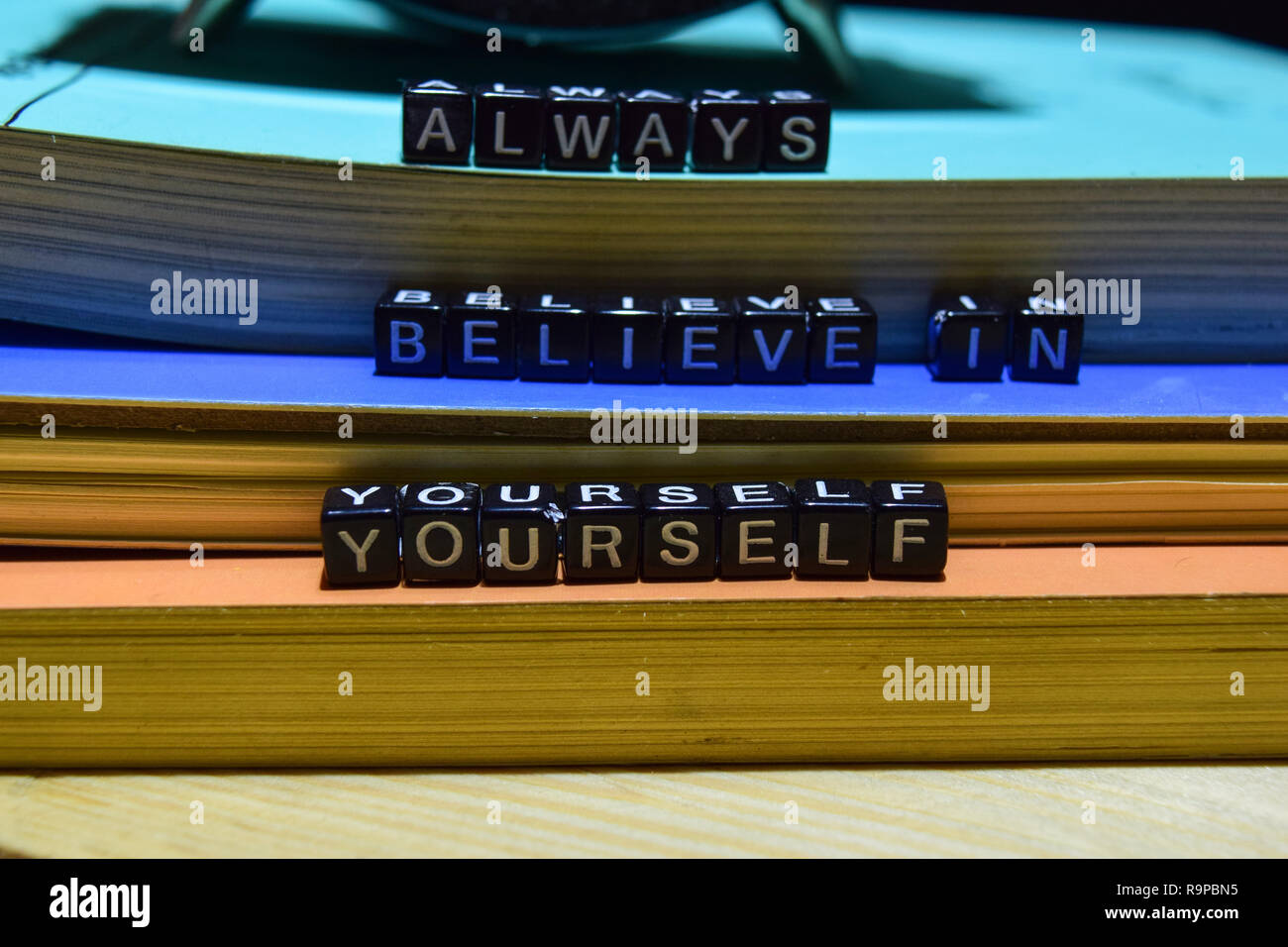 Always believe in yourself written on wooden blocks. Education and business concept on wooden background Stock Photo