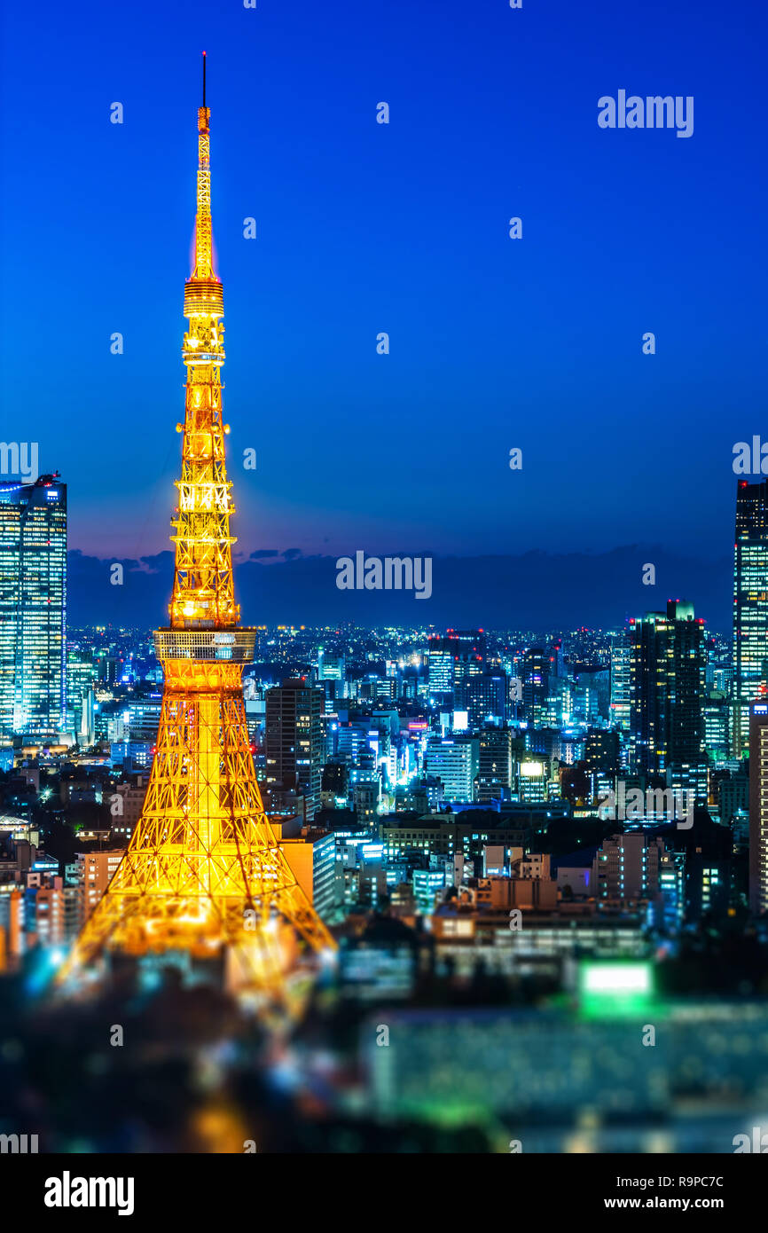 Asia Business concept for real estate and corporate construction - city view and tokyo tower under neon night in tokyo, Japan with tilt shift, miniatu Stock Photo
