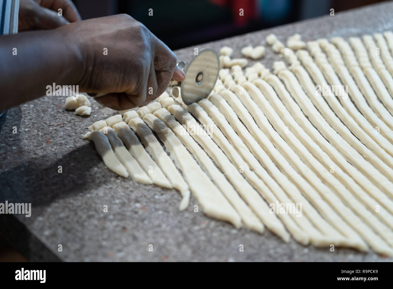 Preparing Nigerian Chin Chin in Kitchen at home Stock Photo