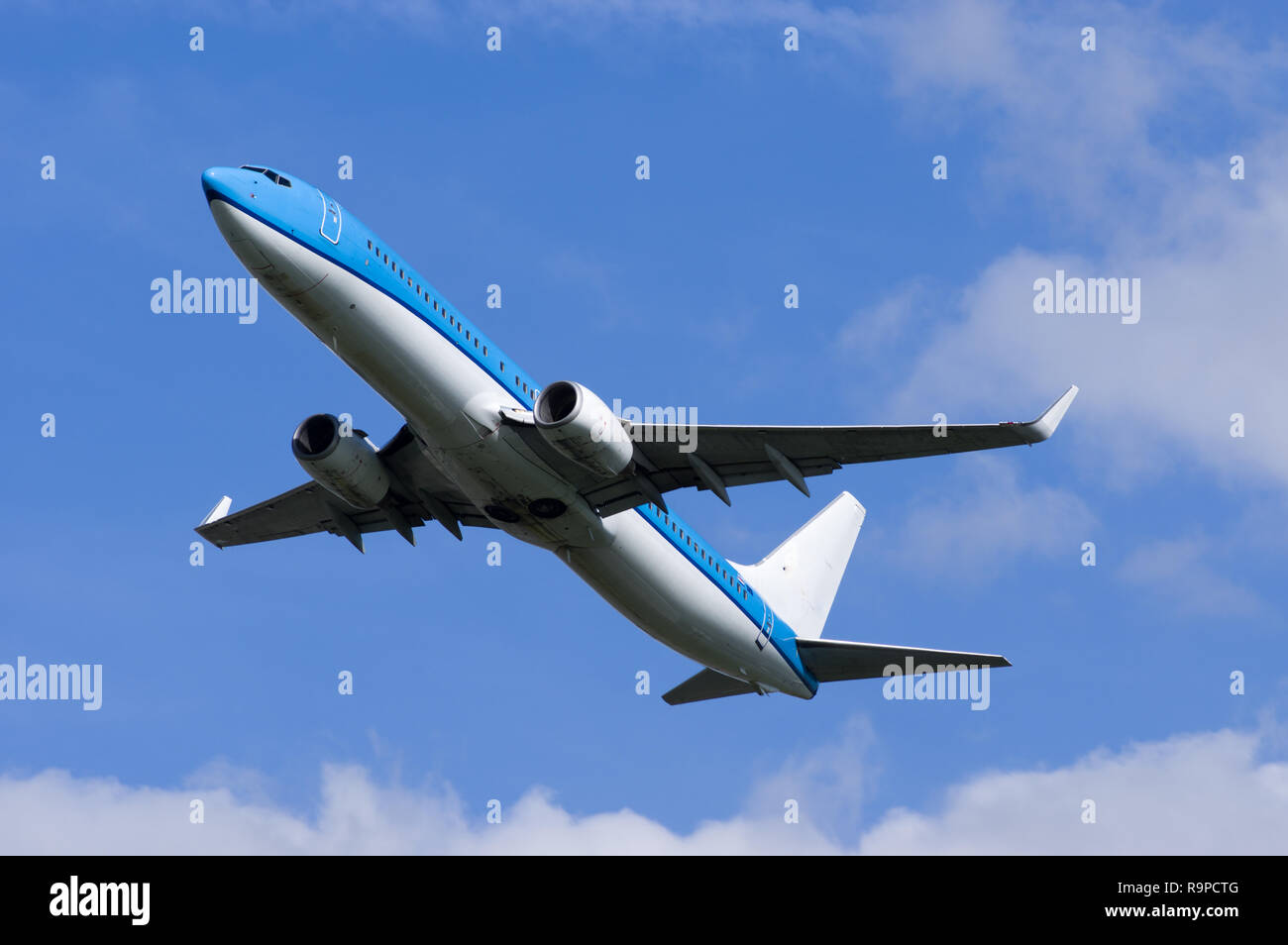 Airplane in flight viewed from the ground Stock Photo