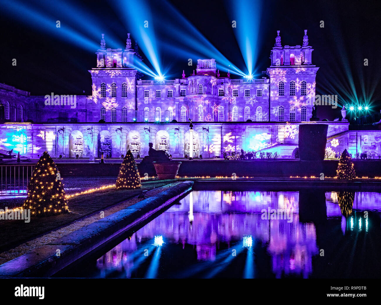 Blenheim Palace and water terrace illuminated with Christmas lights  complete with laser show into the night sky Stock Photo - Alamy