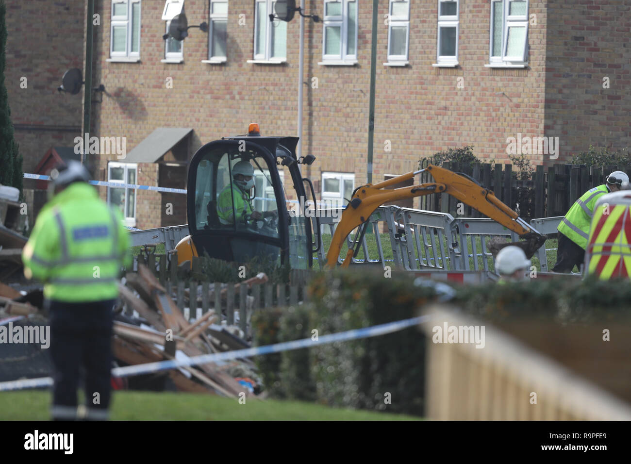 Gas engineers use a mechanical excavator at the scene in Launcelot Close, Andover, where Hampshire Police say that the body of a man has been found after an explosion caused a building to collapse this morning. Stock Photo