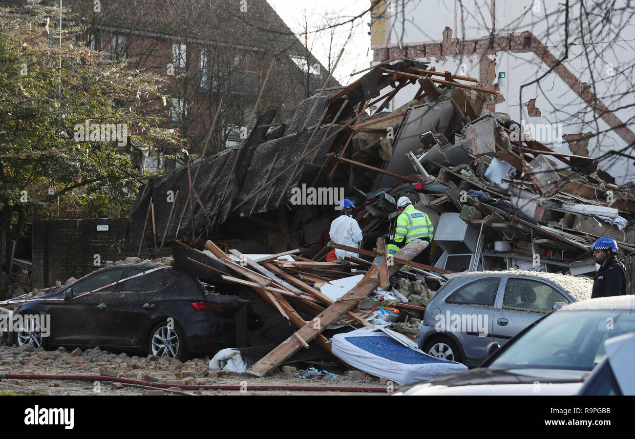 A gas engineer and a police worker at the scene in Launcelot Close, Andover, where Hampshire Police say that the body of a man has been found after an explosion caused a building to collapse this morning. Stock Photo