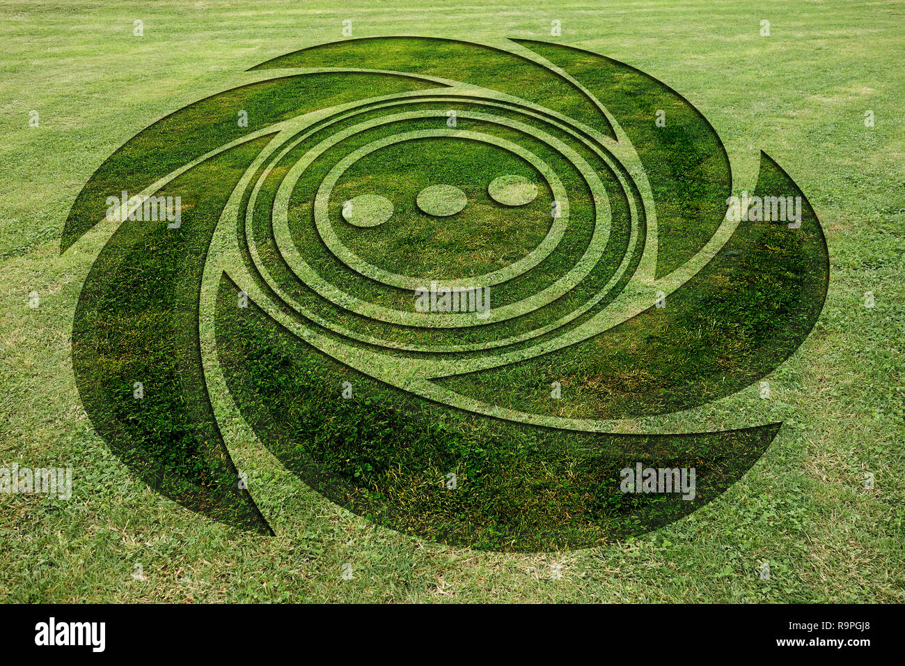 Concentric spiral circles fake crop circle in the meadow Stock Photo
