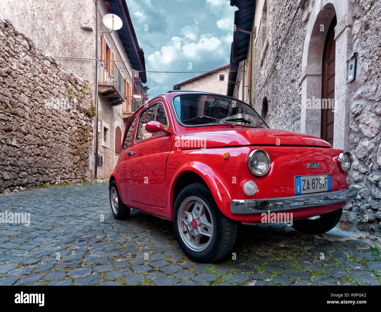 Pescasseroli, Italy - 2017 august: Red vintage city car fiat 500 parked in old village Stock Photo