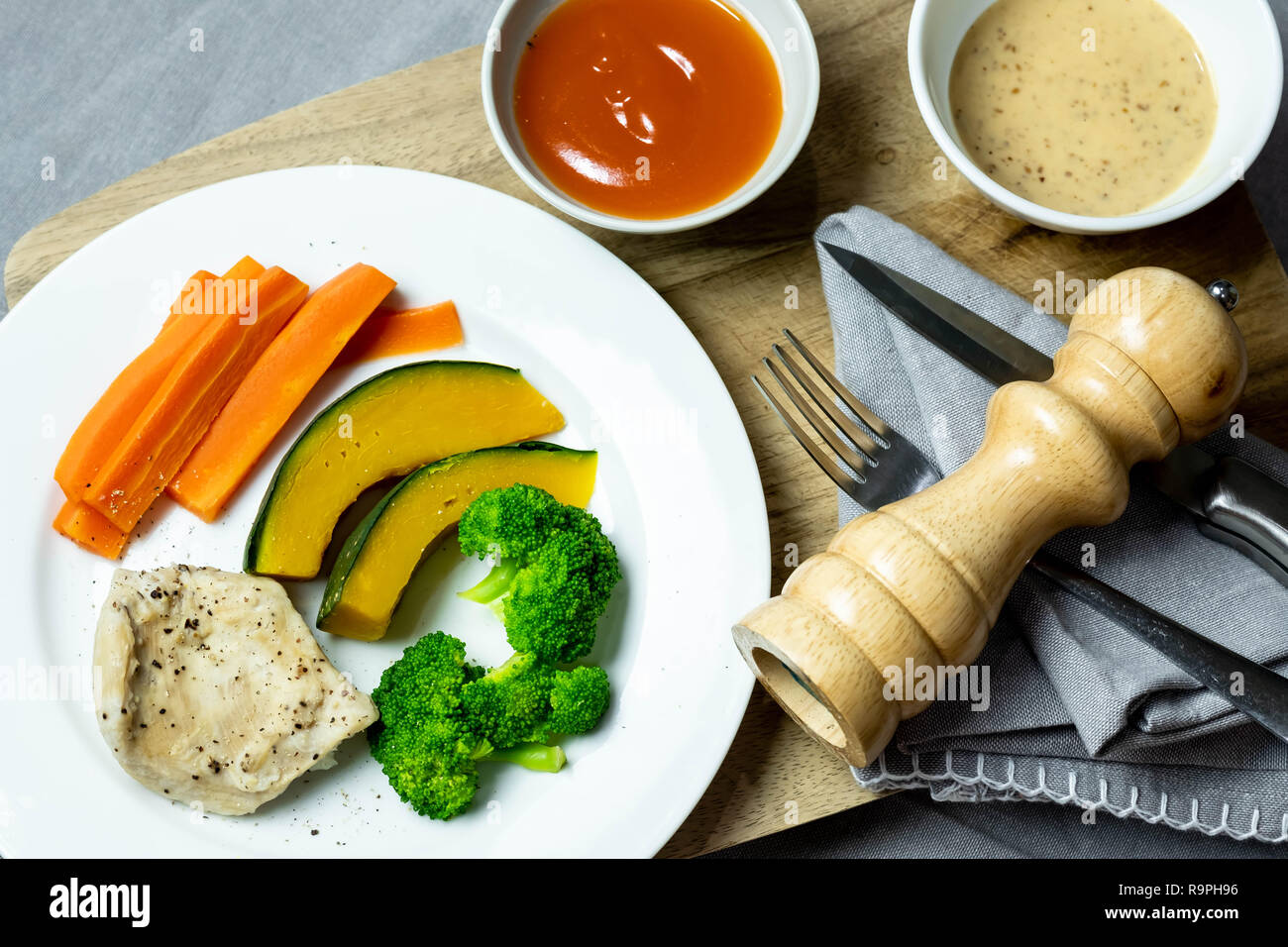 Grilled chicken steak with broccoli, pumpkin and carrot boiled, dinner food. Stock Photo